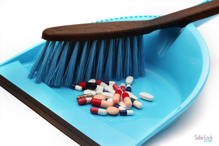Image of a brush sweeping pills into a dust pan.